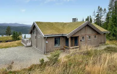 a house with a grass roof on top of a hill at Lovely Home In Gålå With Sauna in Gålå