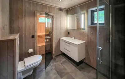 a bathroom with a toilet and a sink and a shower at Lovely Home In Gålå With Sauna in Gålå