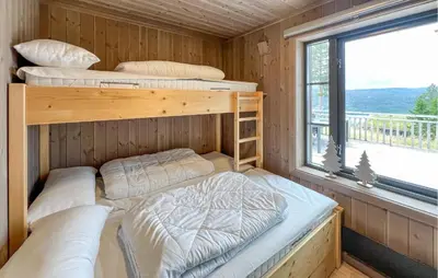 two bunk beds in a room with a window at Lovely Home In Gålå With Sauna in Gålå