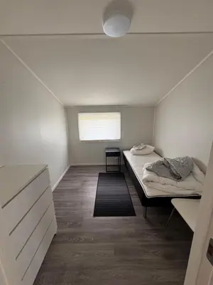 a bedroom with two beds and a window at Steinkjer, 5 room apartment in Steinkjer