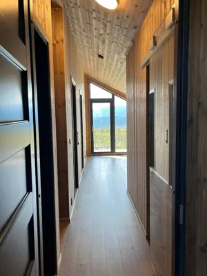 a hallway with a large window in a building at Modern and cozy mountain cabin - panoramic view! in Torvetjørn