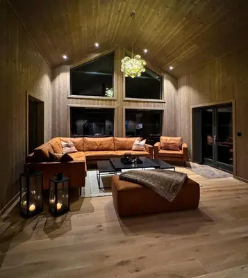 a living room with a couch and a table at Modern cottage in the heart of the Sunnmøre Alps in Sykkylven