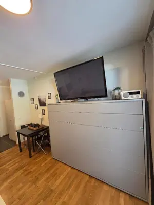 a flat screen tv sitting on top of a dresser at 
