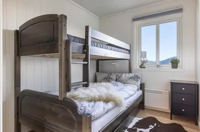 a bedroom with a bunk bed with a furry pillow at Mountain Dream in Vossevangen