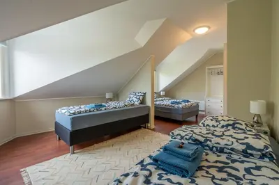 a bedroom with two beds and an attic at Big, Bright & Beautiful - with 6 Large Bedrooms in Bergen