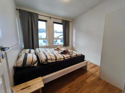 a bedroom with a bed with a teddy bear on it at Modern 3-Bedroom Apartment in Central Voss - Prime Location in Vossevangen