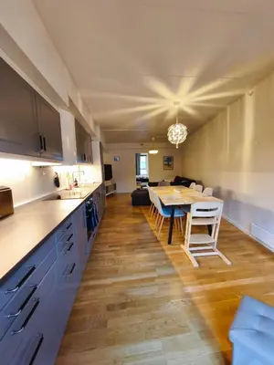 a kitchen and living room with a table and a dining room at Modern 3-Bedroom Apartment in Central Voss - Prime Location in Vossevangen