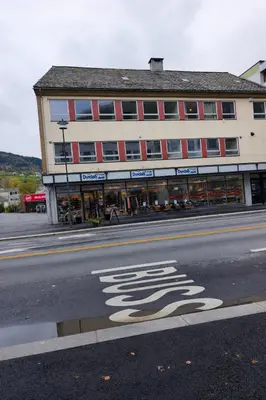 a building on the side of a street with a store at Modern 3-Bedroom Apartment in Central Voss - Prime Location in Vossevangen