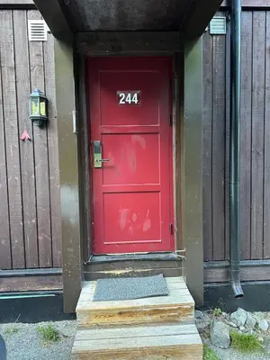 a red door with the number on it at Ski in ski out apartment with sauna in Hemsedal