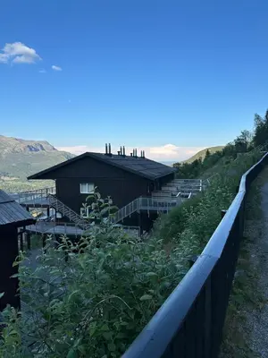 a farm with a fence and a building at Ski in ski out apartment with sauna in Hemsedal