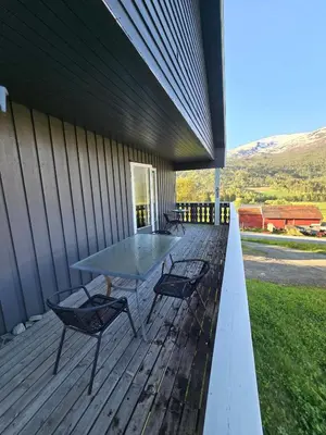 a patio with a table and chairs on a deck at Brendefur Panorama in Hornindal