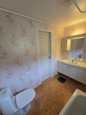 a bathroom with a toilet and a sink and a mirror at Brendefur Panorama in Hornindal
