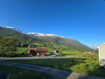 a view of a mountain with a house and a road at Brendefur Panorama in Hornindal