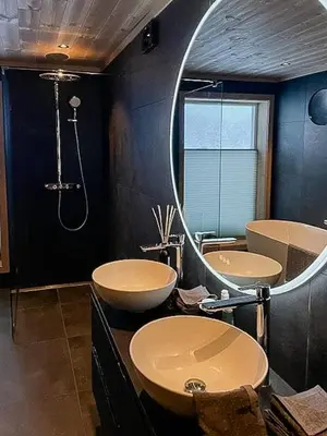 a bathroom with two sinks and a large mirror at Modern Cabin With Views Of Langsua National Park in Etnedal