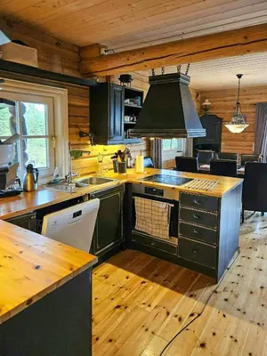 a kitchen with wooden floors and a stove top oven at Family Cabin With Views Towards Solentoppene in Nymoen