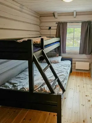two bunk beds in a room with a window at Family Cabin With Views Towards Solentoppene in Nymoen