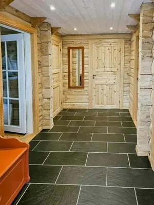 a large room with a stone floor and a door at Family Cabin With Views Towards Solentoppene in Nymoen