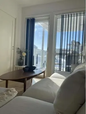 a bedroom with two beds and a table and a window at Workinntoppen in Lii