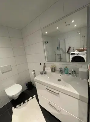 a bathroom with a sink and a toilet and a mirror at Workinntoppen in Lii