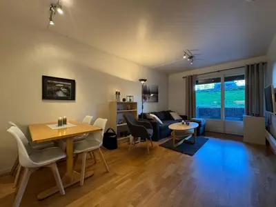 a living room with a table and a couch at Central Apartment in Geilo in Geilo