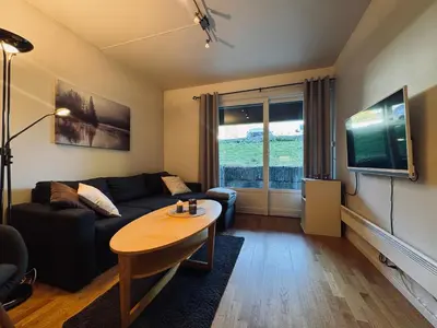 a living room with a couch and a table at Central Apartment in Geilo in Geilo