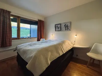 a bedroom with a large bed and a window at Central Apartment in Geilo in Geilo