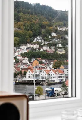 a view of a town from a window at Central, lovely apartment with a unique view in Bergen