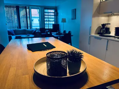 a table with two potted plants on top of it at Central Apt - Steps to Fish Market and Bryggen in Bergen