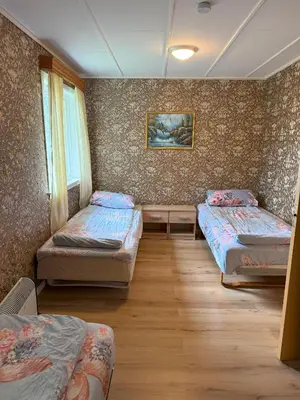 a room with three beds and a window at Great House with a panoramic view in Storsæter