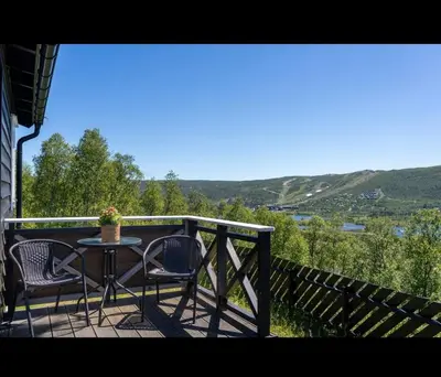a table and chairs on a balcony with a view at Charming cabin with lovely views at Geilo in Geilo