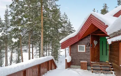 a log cabin in the snow with a fence at Amazing Home In Lesjaverk With Wi-Fi in Bjorli