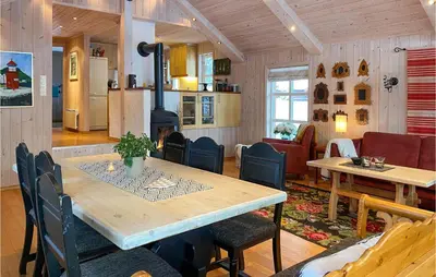 a dining room with a table and a fireplace at Amazing Home In Lesjaverk With Wi-Fi in Bjorli