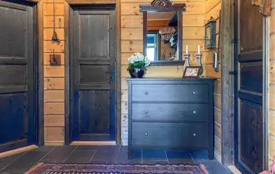 a wooden room with a dresser and a mirror at Pet Friendly Home In Bjorli With Sauna in Bjorli