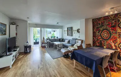 a living room with a couch and a table in a room at Awesome Apartment In Ulvik With House Sea View in Ulvik
