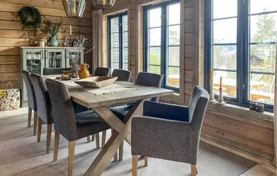 a dining room with a wooden table and chairs at 3 Bedroom Beautiful Home In Lesjaverk in Bjorli