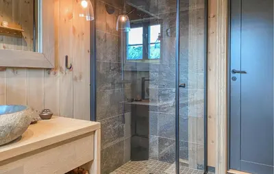 a shower with a glass door in a bathroom at 3 Bedroom Beautiful Home In Lesjaverk in Bjorli