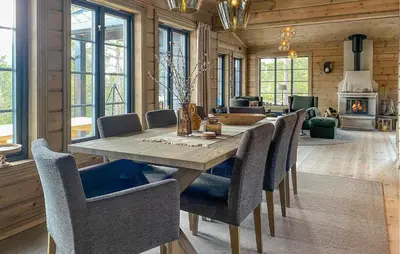 a dining room with a wooden table and chairs at 3 Bedroom Beautiful Home In Lesjaverk in Bjorli