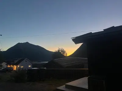 a view of the sunset from the backyard of a house at Home with a view in Lom