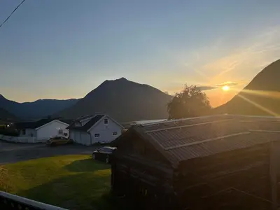 a view of the sunset from the balcony of a house at Home with a view in Lom