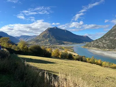 a view of a river with a mountain in the background at Home with a view in Lom