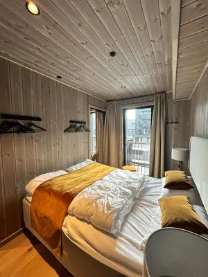 a bedroom with a large bed and a window at New apartment in Hemsedal Fjellandsbyen in Hemsedal