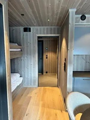 a room with two bunk beds and a hallway at New apartment in Hemsedal Fjellandsbyen in Hemsedal