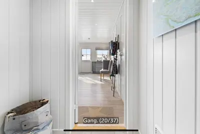 a hallway leading to a dining room with white walls at Hovden Alpin Apartments in Bykle