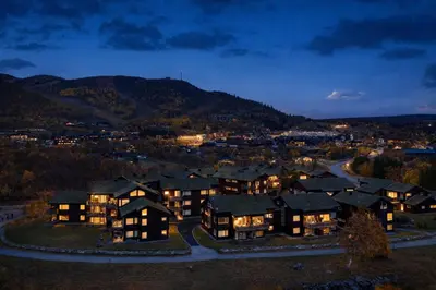 an aerial view of a mansion at night at Geilotunet Apartment - close to everything, free parking in garage, EV in Geilo