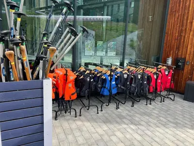 a rack of skis and umbrellas in front of a building at Ski out ski in Luxus Hemsedal in Hemsedal