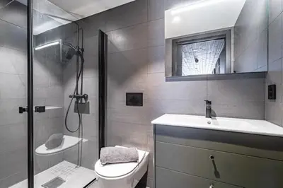 a bathroom with a shower and a toilet and a sink at Ski out ski in Luxus Hemsedal in Hemsedal