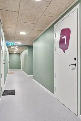 an empty hallway with a door with a sign on it at 28 sqm studio apartment in the heart of Leirvik in Stord