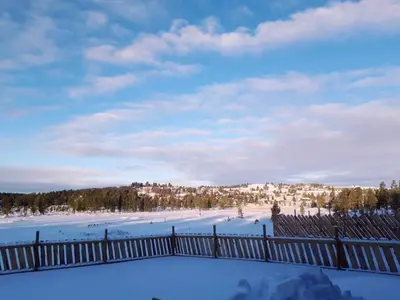 a view of a snow covered field with a fence at Kvamsfjellet - Rondane in Nord-Fron