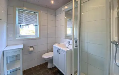 a bathroom with a toilet and a sink and a shower at 3 Bedroom Cozy Home In Sjusjøen in Sjusjøen