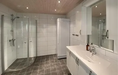 a white bathroom with a shower and a sink at 3 Bedroom Cozy Home In Sjusjøen in Sjusjøen